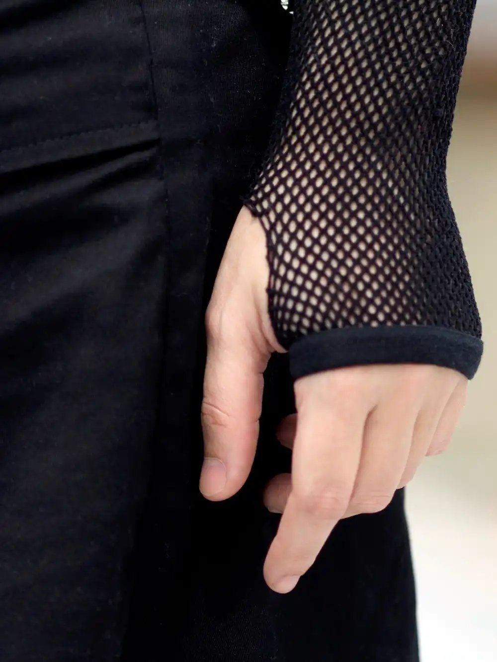 Fishnet sleeve worn by a woman