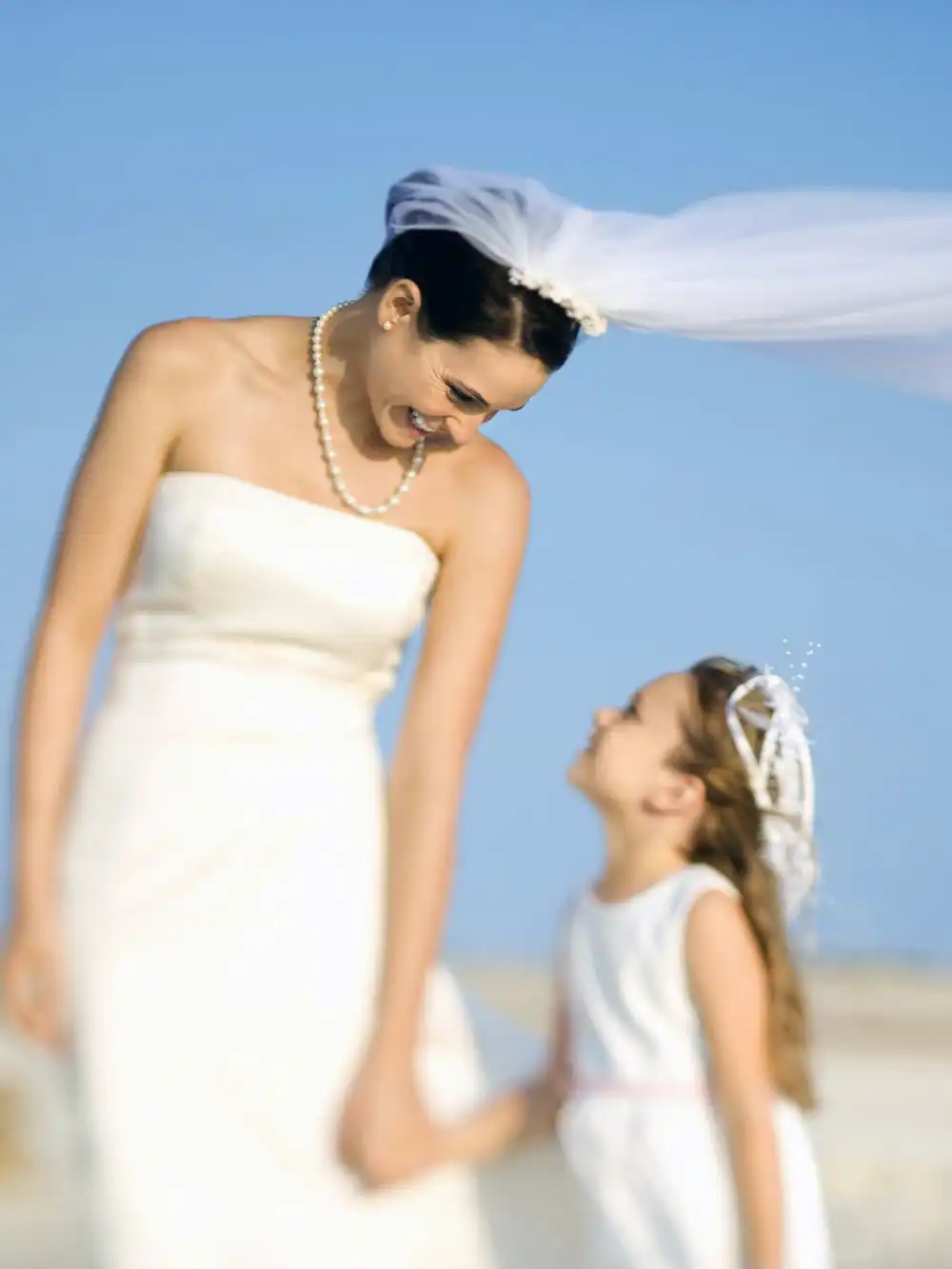 Flower girl and bride wearing a white dress