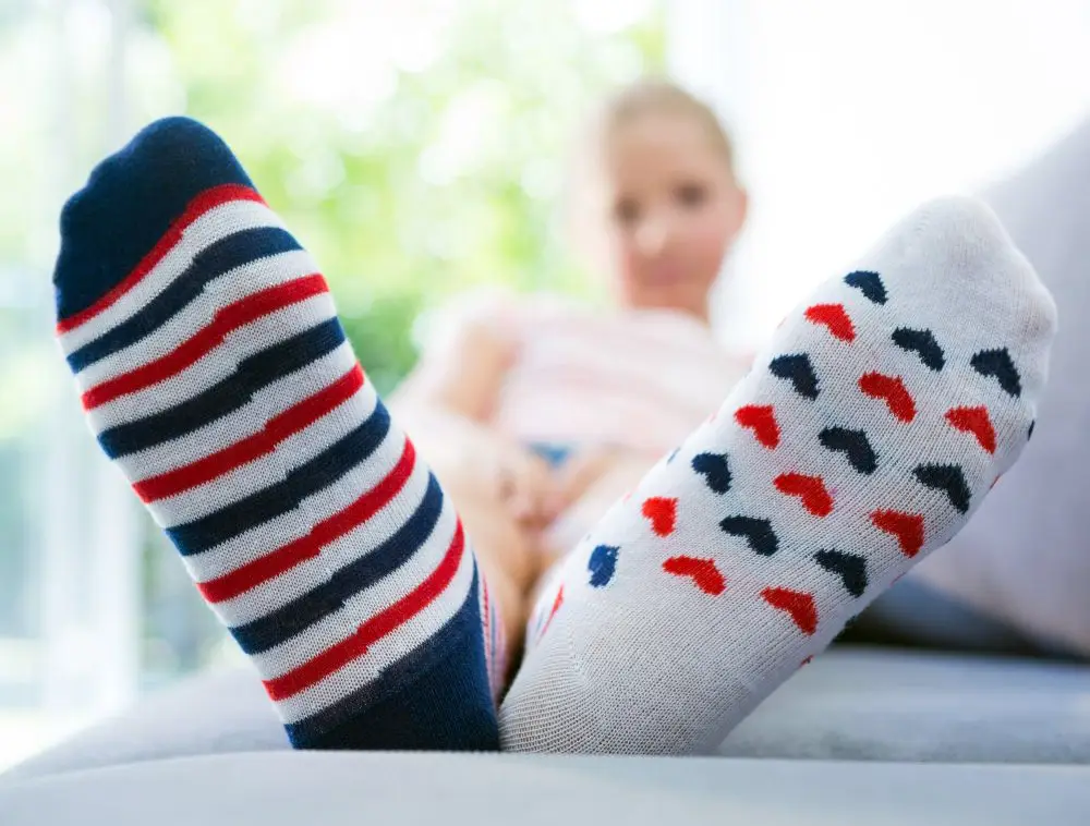 Girl showing her two different socks