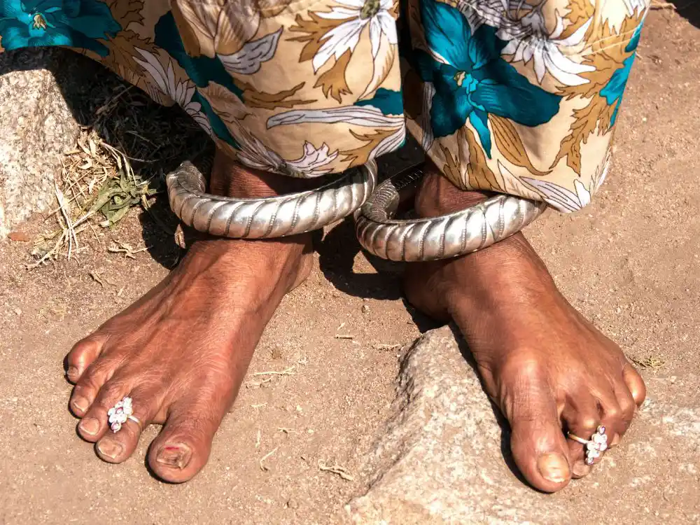 Woman's bare feet with toe-rings and silver ankle bracelets