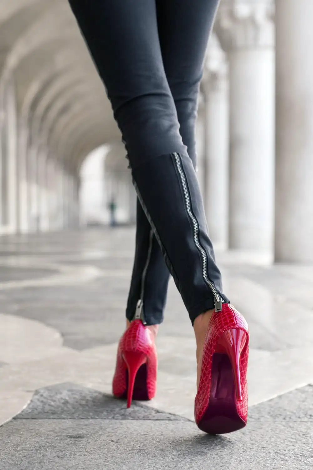 Woman Walking in Black Pants and Red High Heels