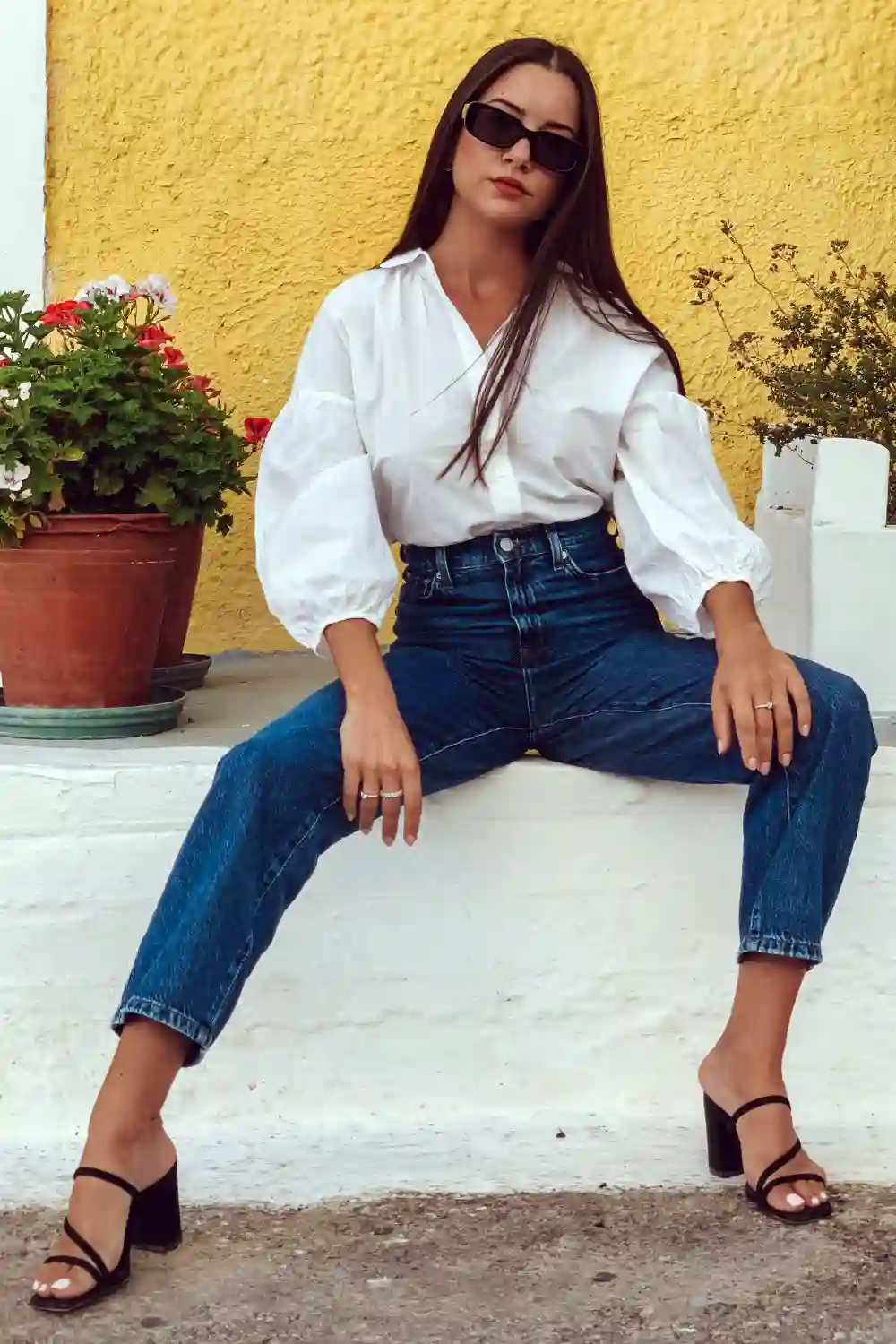 A Woman Wearing White Long Sleeves and Denim Jeans