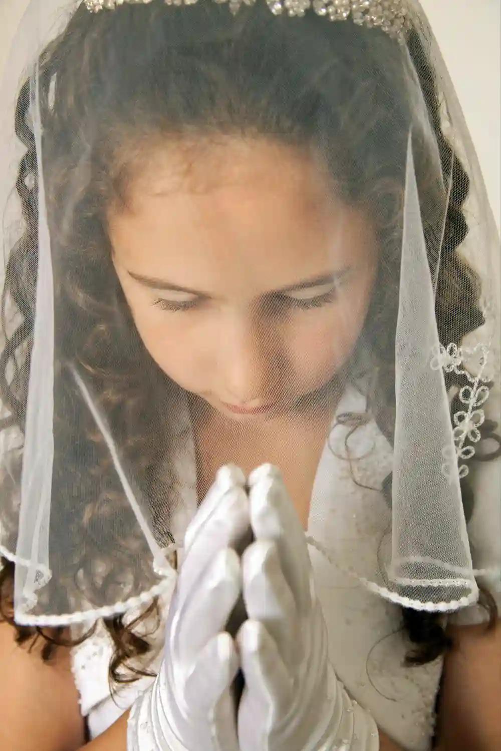 Girl praying for First Communion