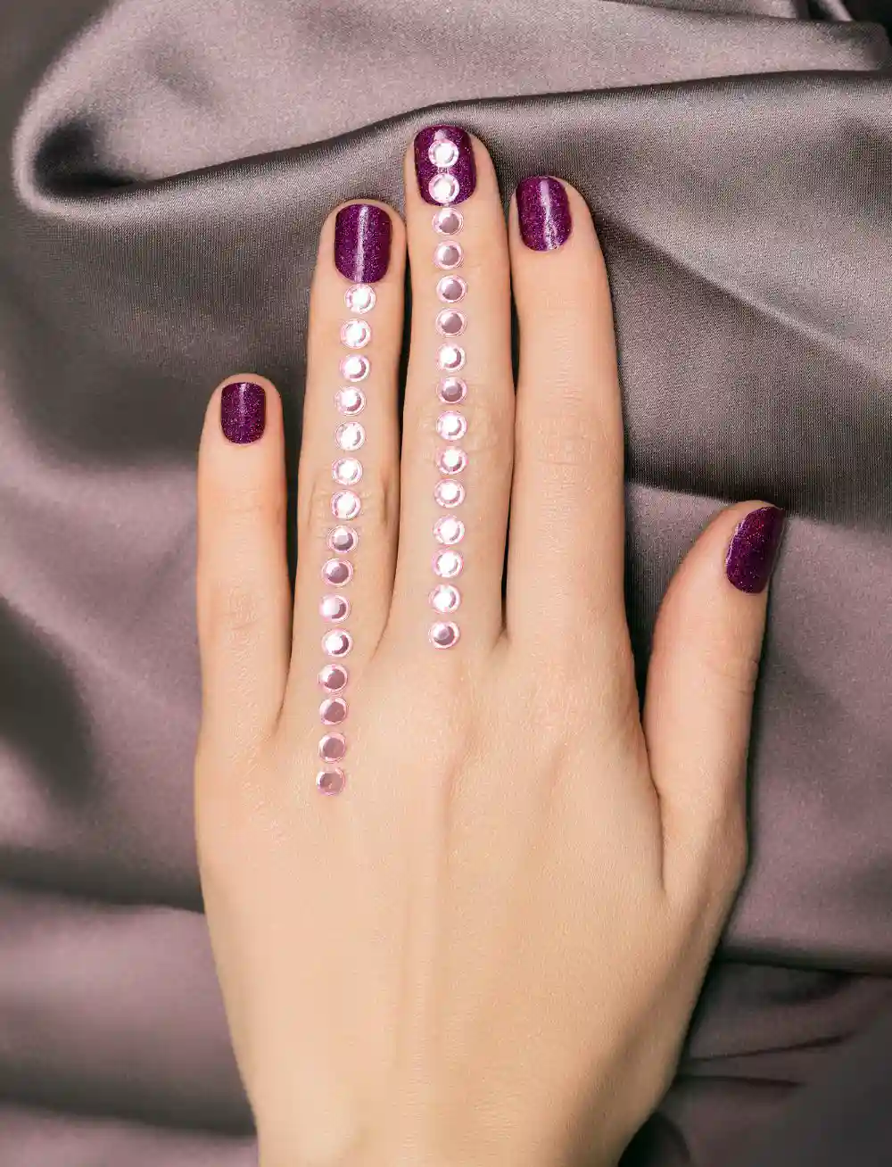 Model hand with purple manicure