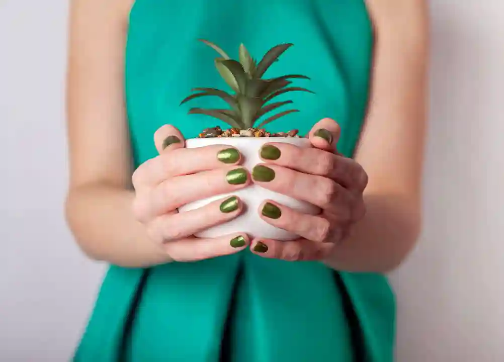 Woman in green dress and with green nails