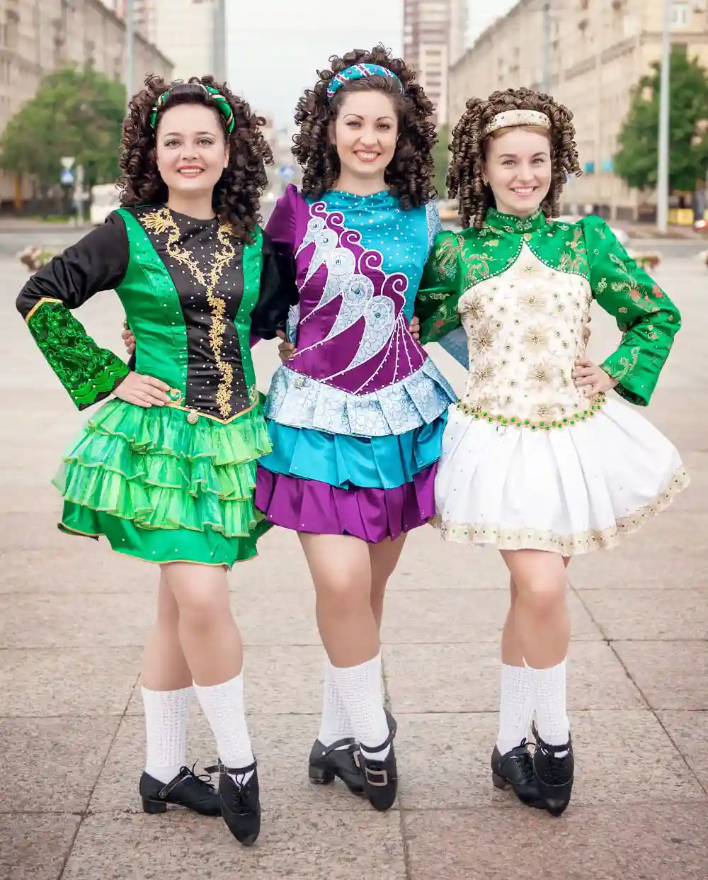 Three women in irish dance dresses posing outdoor