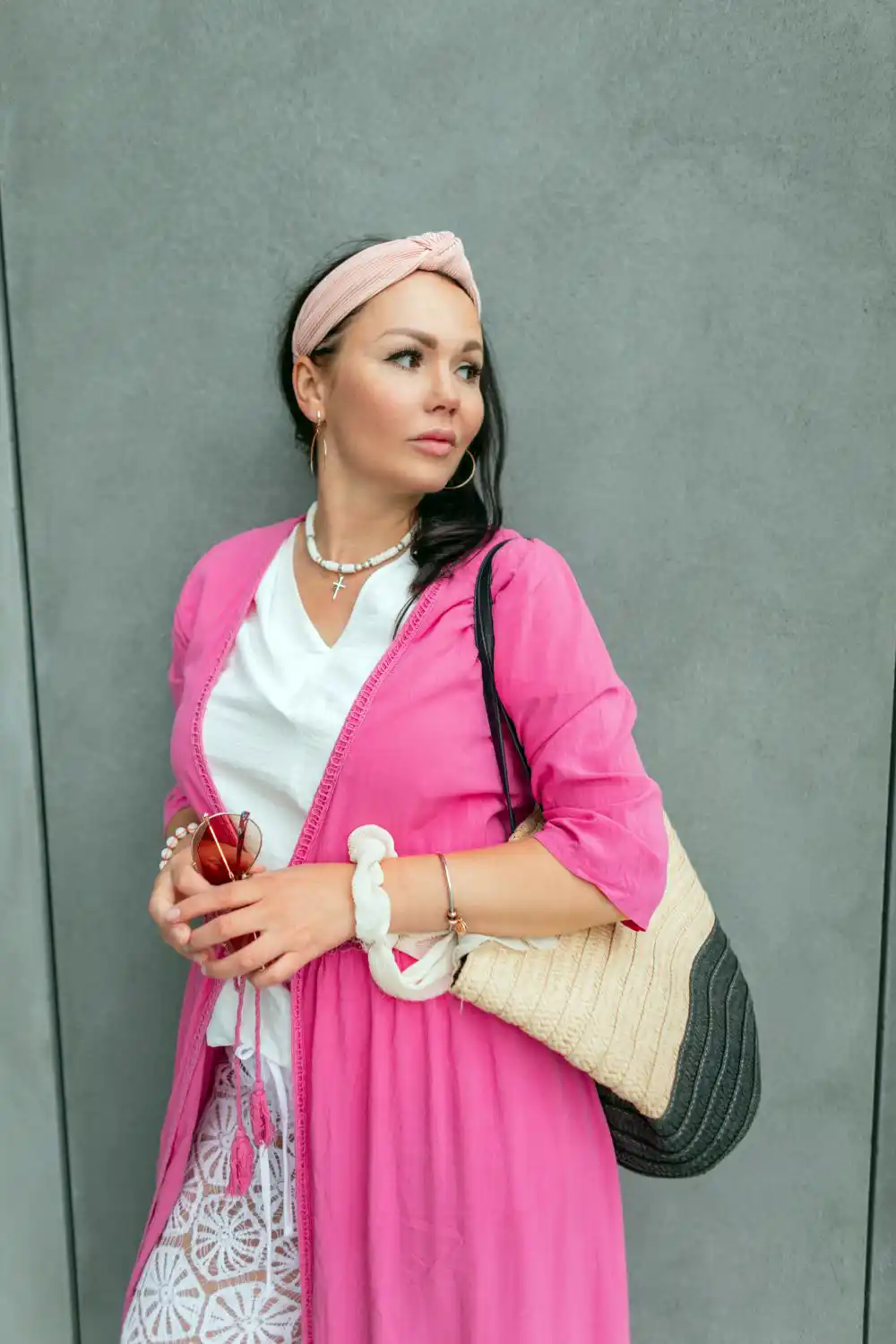Fashionable Woman with a Headband in a Stylish Pink Pareo