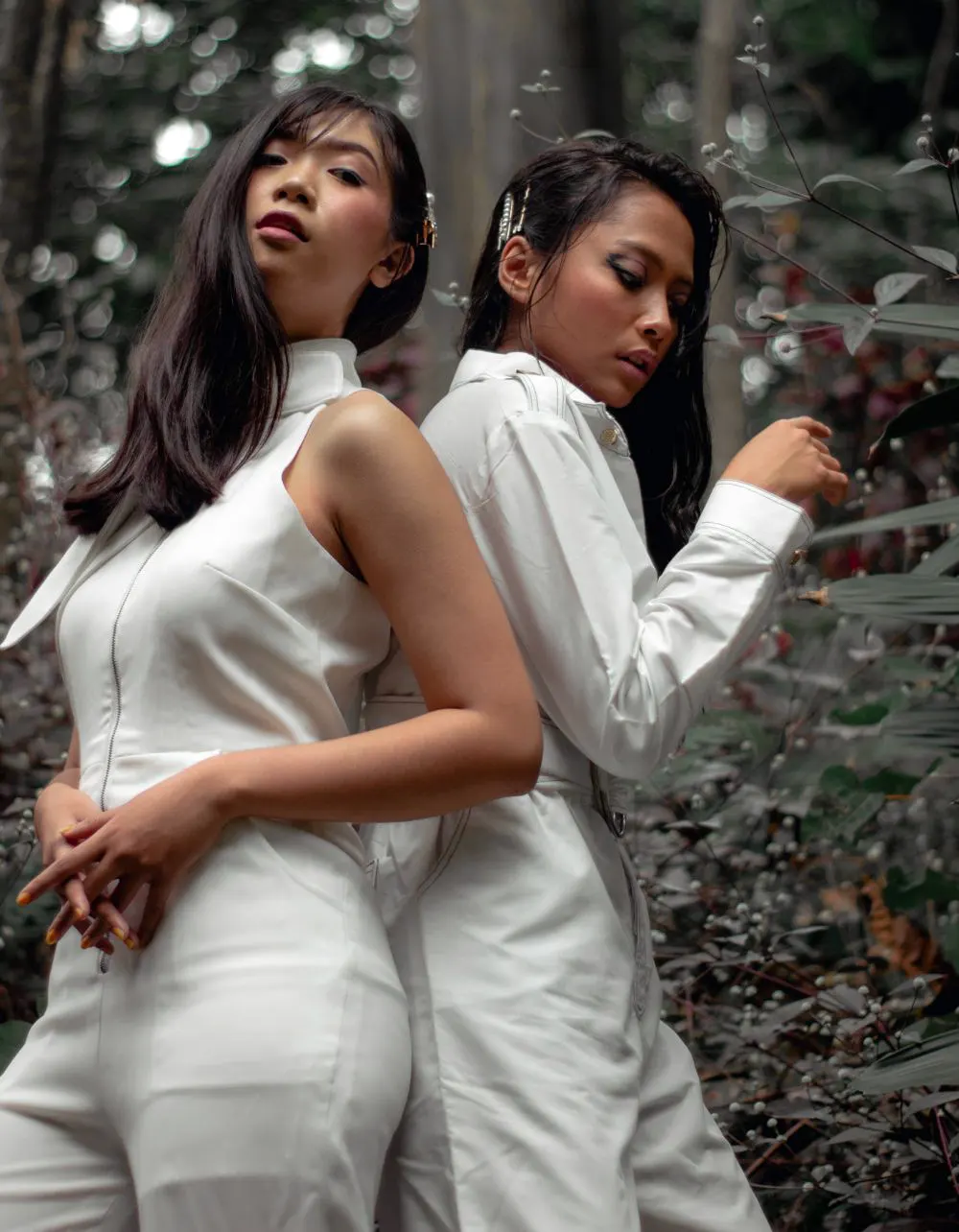 Two Women Wearing White Jumpsuits