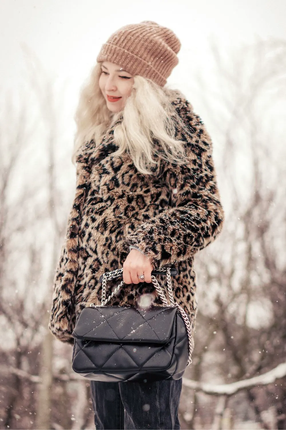 Woman in Winter Carrying Black Handbag