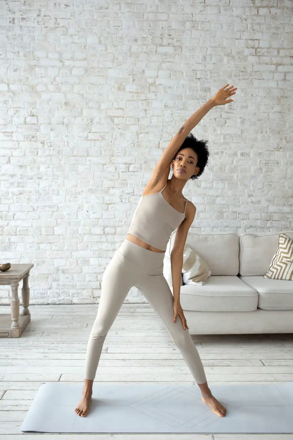 Woman in Beige Tank Top Stretching